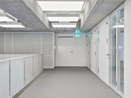 Kantonale Notrufzentrale, Aarau - Innenansicht auf weisse Brandschutztür in weissem Gang